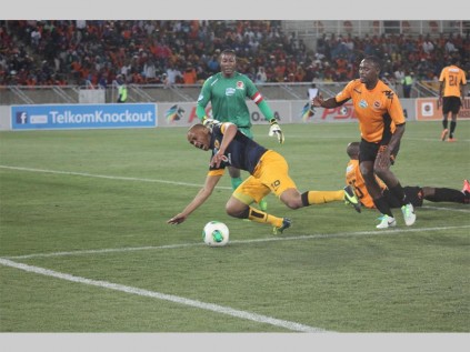 Kaizer Chiefs midfielder, Siyabonga Nkosi heads to the goalpost to score. Trying to stop are Polokwane City FC defenders Tlou Molekwane and Prince Hlela and the goalkeeper, Nkueni Mayala.