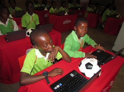 Ntsako Sibiya, gr. 5 learner and Patronel Mathebula, a gr. 4 learner give their new laptops a go.