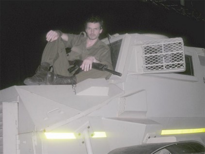 An actor stand on top of a military Nyala to demonstrate how people were intimidated and forced to leave their homes.