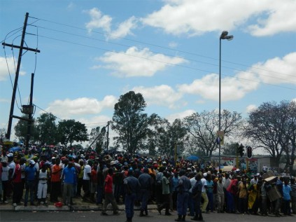 Police try to calm the situation when Disteneng residents barricaded Mandela Drive.