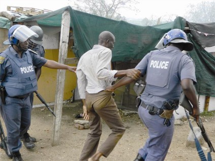 A man is arrested during a protest by Disteneng residents who do not want to be relocated.