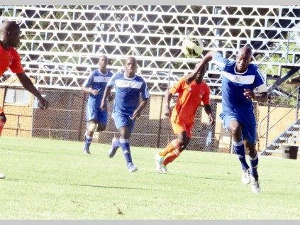 Blue Rocks' captain, Adriaan Mavundza (in blue, in front) pushes forward during the game at Giyani Stadium on Saturday.
