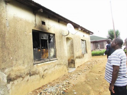 Ximausa village headman Khasele Golele inspects the house belonging to Mamayila Nkuna, who was burnt to death amid accusations of being a witch.