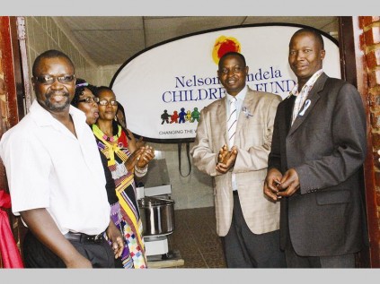 Rogers Tshivhase (Khalavha, acting chief), Alunamutwe Rannditsheni, Mampe Ntsedi (Nelson Mandela Children's Fund, programme specialist), Richael Tshivhase and Nthambeleni Ramanyimi (Far North Community Care and Development, director) officially open the Mutsindo Bakery and Confectionary Cooperative at Khalavha Village on Saturday.