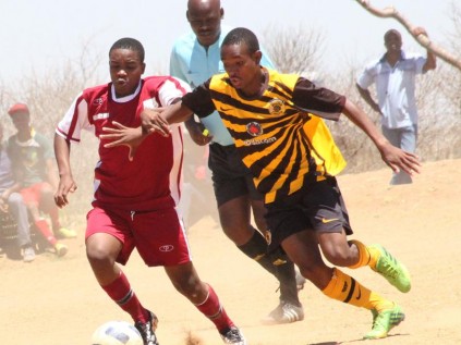 Daniel Thabela of Old Rock FC and Mpho Laka of Naughty Boys wrestle for ball posession during their qualifying match for the Mayoral Cup on Sunday. Naughty Boys won 1-0.