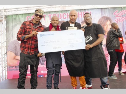 Jeward Maphoto (Easy Waves Style-a-Thon, judge), Elly Majola (Easy Waves, representatives) and Sandile Lephando (Easy Waves, representative) hand over a R20 000 cheque to Lesiba Mashao. Mashao won the Style-a-Thon, part of the Easy Waves Can't Touch This roadshow that made a stop in Seshego recently.