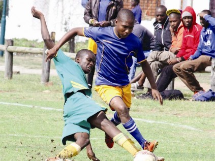 Moses "Iniesta" Ramoshaba of FC Zamalek avoids a tackle from Twente FC player, David Ranoko, in the semi-finals of the Westenburg Mini Challenge, which FC Zamalek won 5-3 on penalties.
