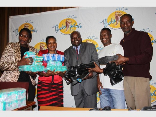 Pola Mathonsi (Phalaphala FM executive producer), Grace Mauda (Mutavhe Primary School, principal), John Nethenzheni (Londolani Primary School, principal), Lufuno Munonde (Phalaphala FM, marketing executive) and Pat Nephawe (Phalaphala FM, presenter) with some of the school shoes and sanitary towels the station donated to 50 schools in the Vhembe district.